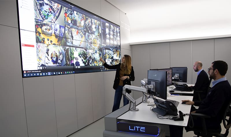 video wall and operators A team observes a large video wall from operator workstations